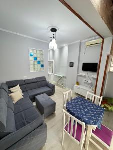 uma sala de estar com um sofá e uma mesa em Solei Apartments em Saranda