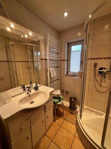 a bathroom with a sink and a shower at Ferienwohnung Claudia in Oberammergau