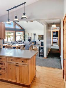 a kitchen and living room with a table and chairs at The River House- Riverfront Cabin-hot tub, gazebo! in Packwood