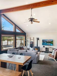 a living room with a couch and a table at The River House- Riverfront Cabin-hot tub, gazebo! in Packwood +33 photos