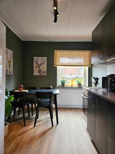 uma cozinha com mesa e cadeiras num quarto em Lilla Älvbrogården i stan em Avesta