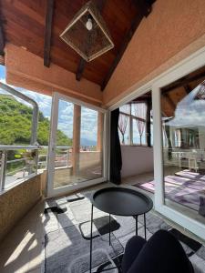 a room with a table and windows with a view at Deni house in Prizren