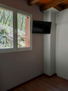 an empty room with a window and a stove at A l' orée des bois, maison avec étang in Saint-Sylvestre