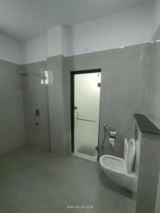 a bathroom with a toilet and a sink and a door at Executive House in Lucknow
