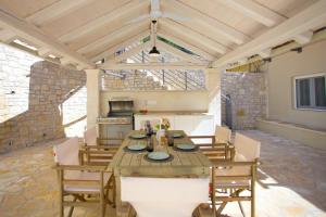 a kitchen with a table and chairs in a room at Villa TheView in Katávolos