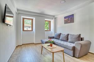 a living room with a couch and a table at Apartments Pavic in Risan