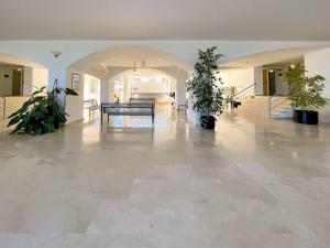 a large living room with a table and potted plants at Bga rentals Punta Prima in La Pineda +12 photos
