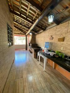 a large kitchen with a table in a room at Casa das orquídeas in Santana do Riacho +16 photos