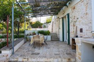 a patio with a table and chairs in a building at Trullo Masiello in Putignano