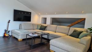 a living room with a couch and a table at MaMi Apartments - Cloud 9 in Pliezhausen