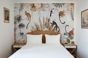 a bedroom with a bed with a monkey wallpaper at Casa Apollo Guesthouse in Faro