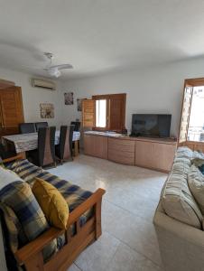 a living room with a couch and a television at Casa Plaza Relleu in Relleu