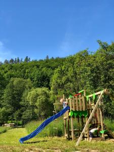a child on a slide on a playground at Dom w Dolinie Zdrowia in Wleń