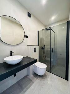 a bathroom with a toilet and a sink and a shower at SmartStay Johnny in Podstrana +22 photos