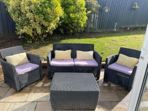 a group of four wicker chairs and a table at Porthkidney Suite, Carbis Bay, St Ives, free parking, near beach in Carbis Bay
