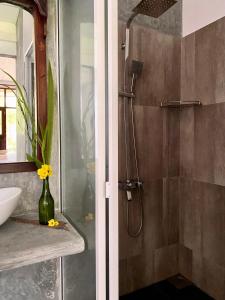 a bathroom with a shower and a sink at The Dale Mirissa in Mirissa