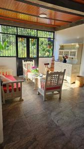 a room with a room with chairs and windows at Entre Cantos - Hospedaje Rural in Ibagué