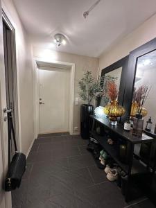 a room with a hallway with a door and a table at romslig leilighet til leie in Arendal