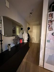 a room with a counter with vases and a refrigerator at romslig leilighet til leie in Arendal