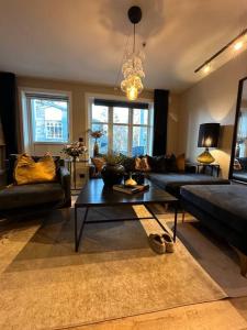 a living room with a couch and a coffee table at romslig leilighet til leie in Arendal