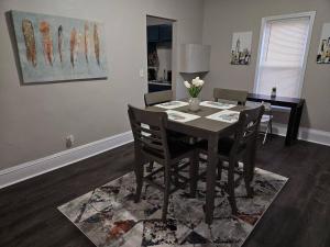 a dining room table and chairs in a room at Elegant 4 BR @Cleveland Clinic Area in Cleveland