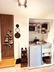 a small kitchen with a stove and a microwave at D52 - das Businessapartment in Dresden