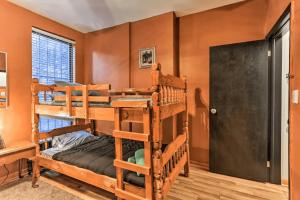 a room with three bunk beds and a door at 1850s historic Row House 7min train to NYC with private backyard in Jersey City