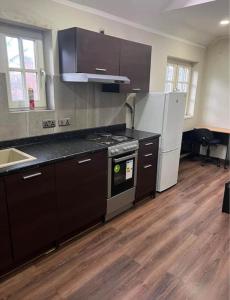 an empty kitchen with a stove and a refrigerator at Unique Studio Flat in City Center in Leicester