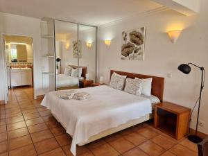 a bedroom with a large white bed in a room at Amazing Studio with Ocean View, Pool and Beach in Lagos +40 photos