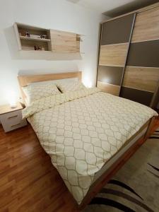 1 dormitorio con 1 cama grande y edredón blanco en Aurum 29a, en Doboj