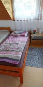 two twin beds in a room with a window at Badacsony Hostel in Badacsonytomaj