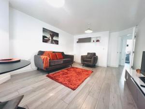 a living room with a couch and a chair at Shazeal Apartment Tipton in Ocker Hill +23 photos