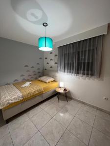 a bedroom with a bed and a table at Stan na dan Jakov in Ljubuški