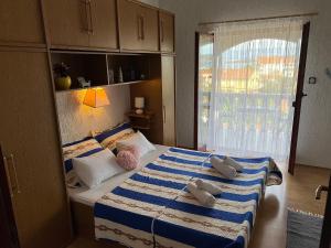 a bedroom with a bed with towels on it at Apartments Dora and Tonka Krk in Porat