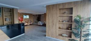a living room with a large wooden wall at Nazik sweet - نازك سويت شقق فندقية in Tabuk