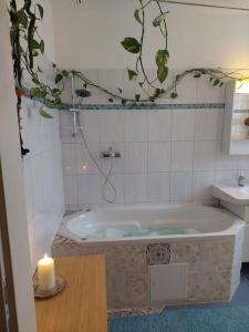 a bath tub with a candle in a bathroom at Schöne helle Wohnung mit Whirlpoolbadewanne in Graz