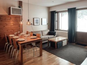 a living room with a table and a couch at Ylläs Chalets Lumina in Ylläsjärvi