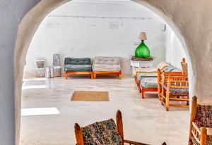 a living room with chairs and a green lamp at Villa Ravino Secret Retreat in Ischia
