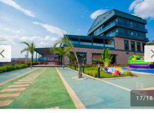 un bâtiment avec une piscine et une aire de jeux dans l'établissement ACACUS ROYALE, à Kigali