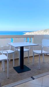 een tafel en stoelen met uitzicht op de oceaan bij Sea View Studios and Apartments Vila Tani-2 in Sarandë