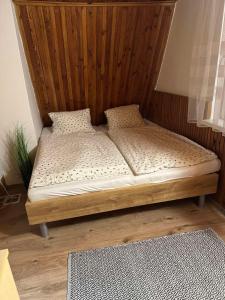a bed sitting in a corner of a room at Chata Family s vírivkou v Slovenskom raji in Spišská Nová Ves