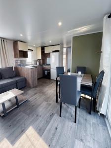 ein Wohnzimmer mit einem Esstisch und einer Küche in der Unterkunft Bondi Beach in Renesse