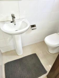 a bathroom with a sink and a toilet at Spacious 2 Bedroom House East Legon Accra in Accra