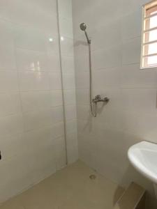 a white bathroom with a shower and a sink at Spacious 2 Bedroom House East Legon Accra in Accra