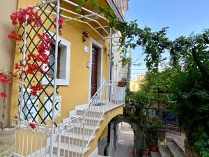 a building with stairs and flowers on the side of it at Sole apartment in Taormina
