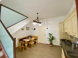 a kitchen and dining room with a table and chairs at Casa FERRARA in Taormina