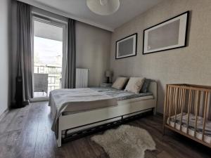 Posteľ alebo postele v izbe v ubytovaní White Swan Apartment