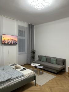 a living room with a bed and a couch at Apartment Vienna in Vienna