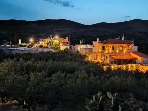 a house sitting on top of a hill at night at Aloni Studio in Azoyirás