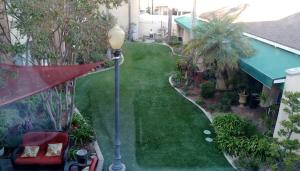 a view of a yard with a street light and a house at Hotel Pacific Garden in Gardena